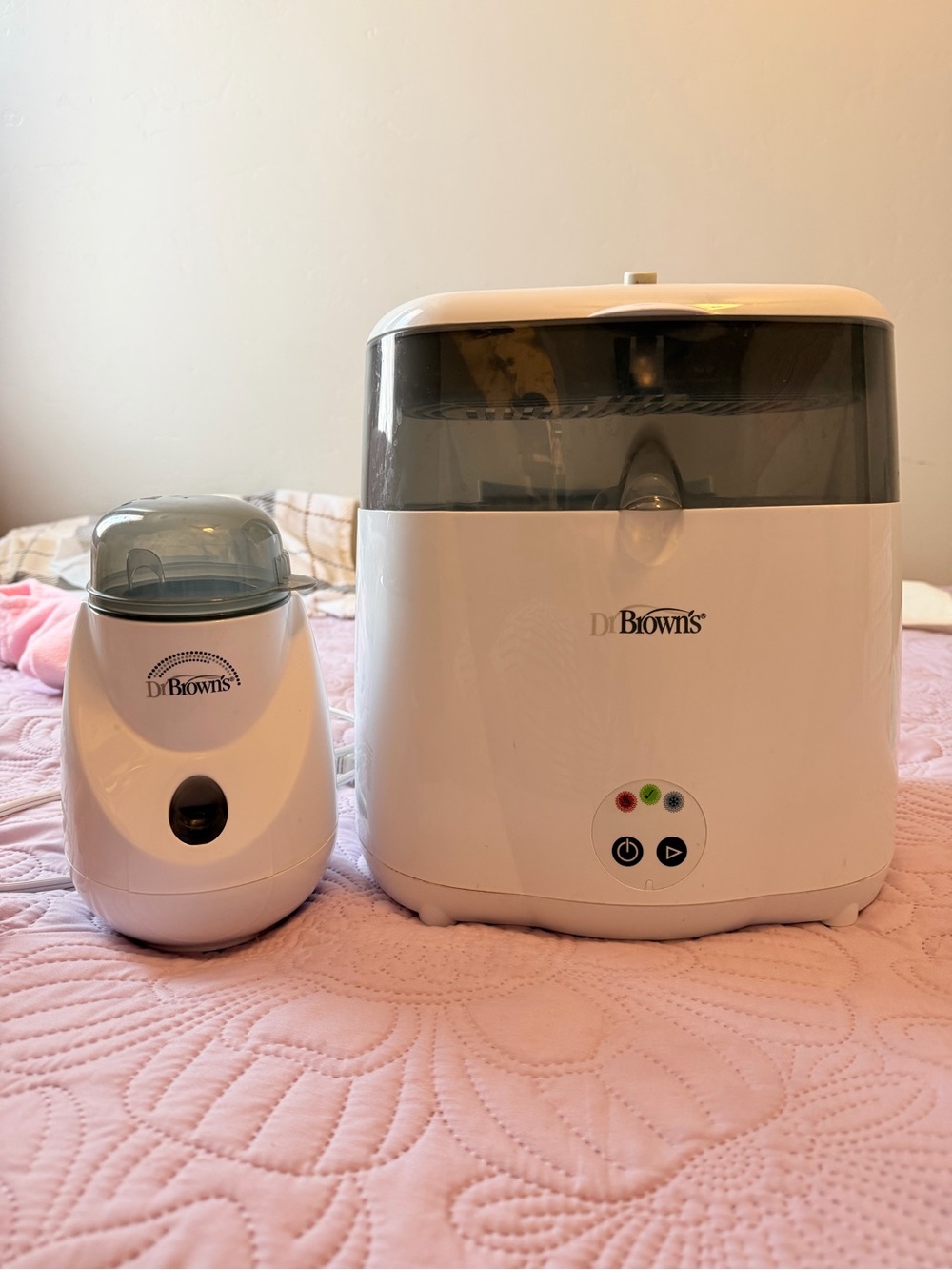 Baby Bottle Sterilizer and Warmer on Bed
